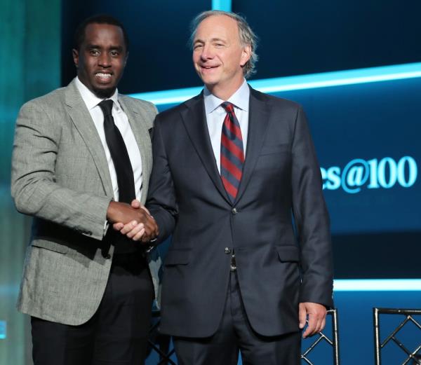 Sean Combs and Ray Dalio shaking hands on stage at the Forbes Media Centennial Celebration in New York City, September 19, 2017