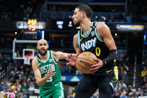 Indiana Pacers guard Tyrese Haliburton (0) controls the ball against Boston Celtics guard Derrick White (9) in the second half at Gainbridge Fieldhouse.