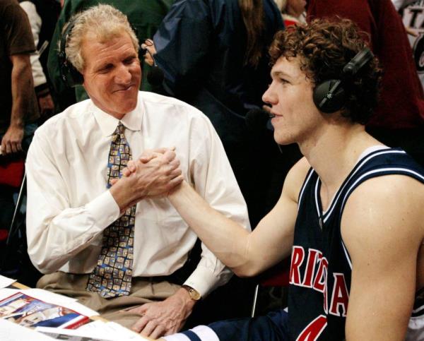 Bill Walton shakes hands with his son Luke after Arizona's win over San Diego State in 2002.