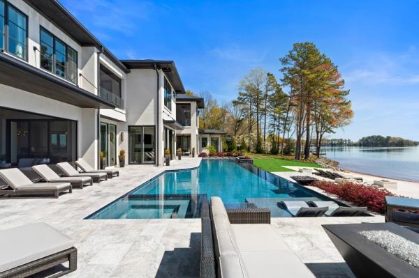 The mansion's outdoor space comes equipped with a chic pool.