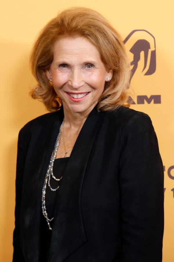 Shari Redstone smiling and wearing a black jacket.