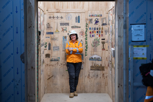 Going up: Lift operator at Anzac railway station co<em></em>nstruction site Melody Forrester with her underground art gallery.