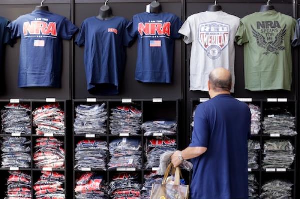 Man looking at T shirts for sale at NRA convention