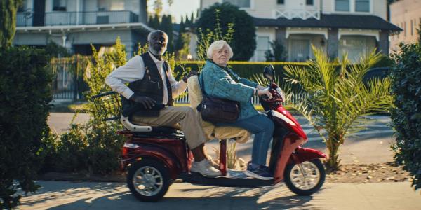 Richard Roundtree and June Squibb ride an electric scooter in Thelma-1